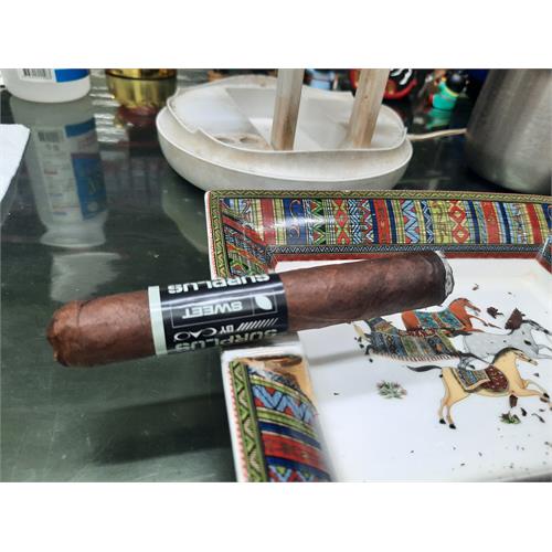 CAO Surplus Sweet cigar burning evenly in ceramic ashtray